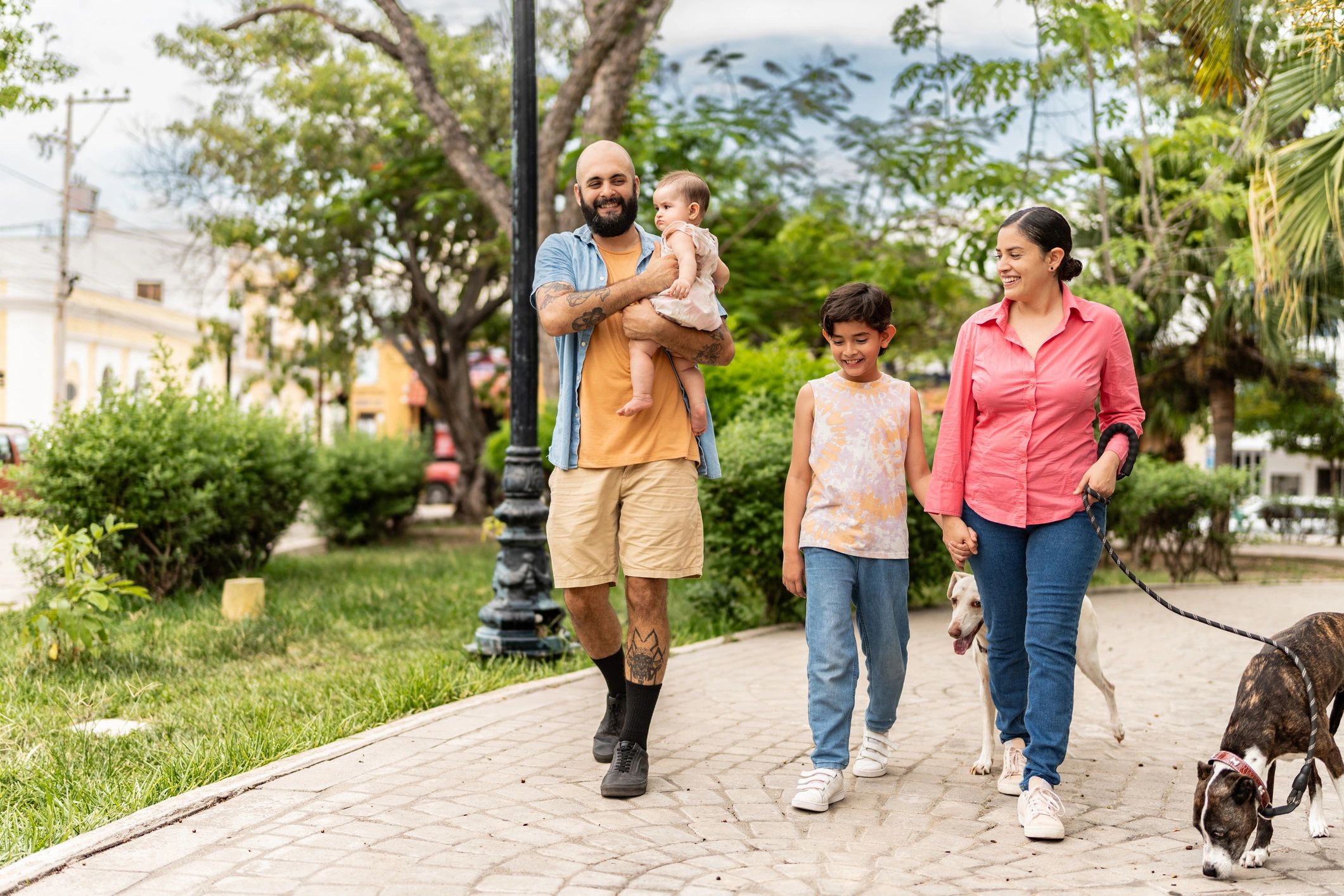 Family walking with dogs in a park